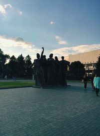 Silhouette of woman against cloudy sky