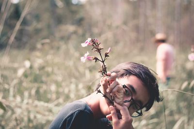 Close-up of woman holding flowering plant