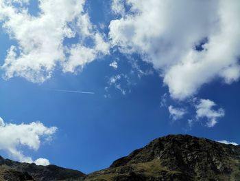 Low angle view of vapor trail against blue sky