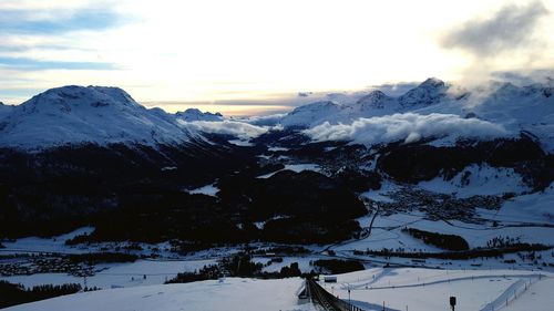 Scenic view of snow covered mountains against sky