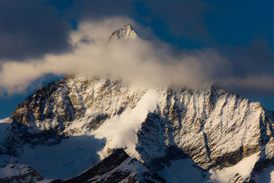 Panoramic view of snowcapped mountains against sky