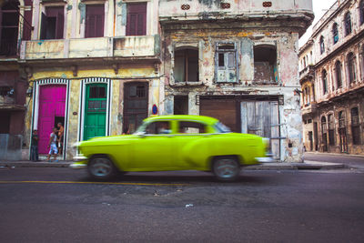 Car parked on street in front of city