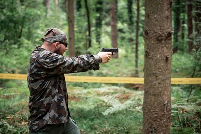 Man holding gun in forest