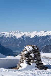 Scenic view of snowcapped mountains against clear blue sky