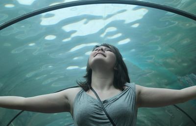 Woman looking up in aquarium