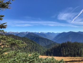 Scenic view of mountains against blue sky