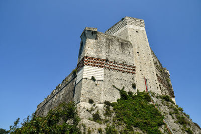 Low angle view of historical building against clear blue sky