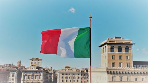 Low angle view of flags against sky