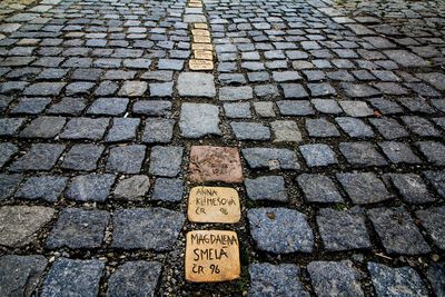 High angle view of text on cobblestone street