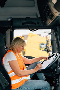 Low section of woman sitting in car