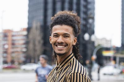 Portrait of smiling young man in city