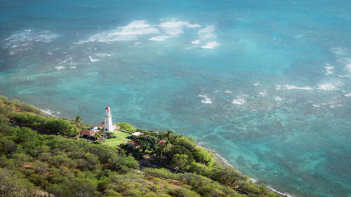 White lighthouse surrounded by azure ocean waters, diamond head lookout near honolulu, hawaii, usa