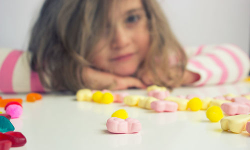 Close-up portrait of smiling girl with toy