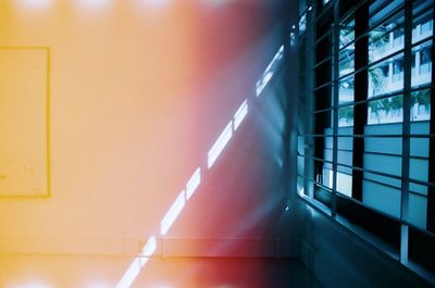 Close-up of railing by wall in building