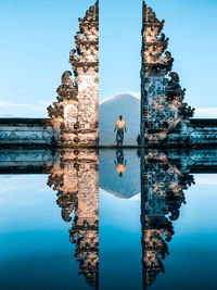 Rear view of boy against blue sky