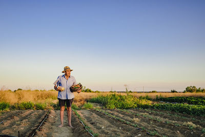 Man standing on field against clear sky