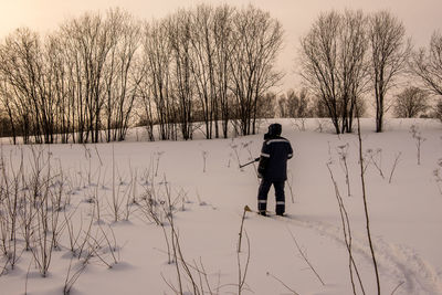 Man on snow covered field during winter