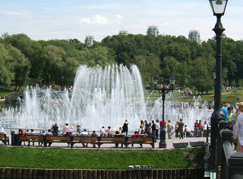 People enjoying fountain in park