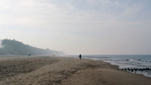 Man on beach against sky