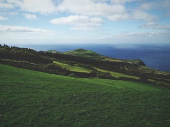 Scenic view of green landscape against sky