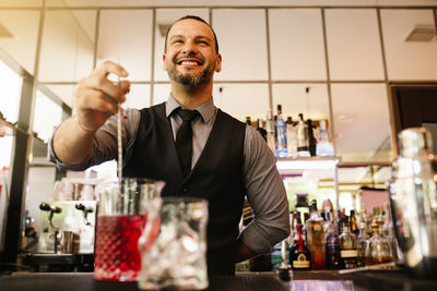 Smiling bartender at bar