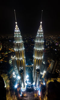 Illuminated cityscape against sky at night