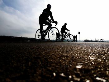 Bicycle parked on road against sky