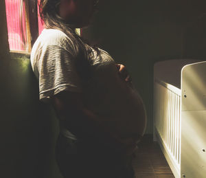 Midsection of woman standing in corridor