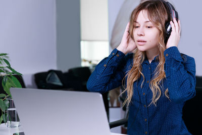 Young woman using laptop at office