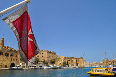 Sailboats in sea against clear blue sky