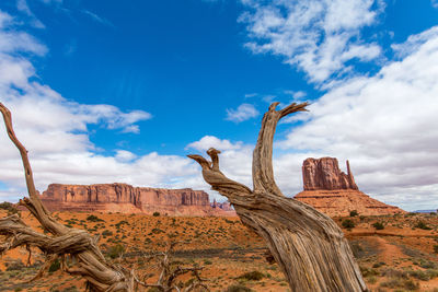 Low angle view of rock formation against cloudy sky