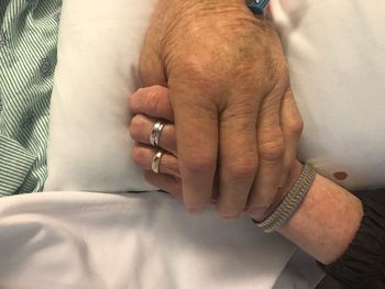 Cropped image of couple holding hands