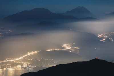 Scenic view of silhouette mountains against sky at night