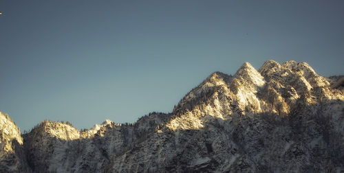 Low angle view of rocks against clear sky