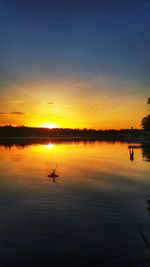 Scenic view of lake at sunset