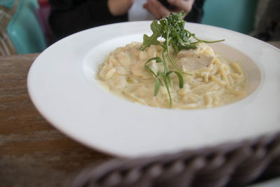 High angle view of spaghetti served in bowl on table