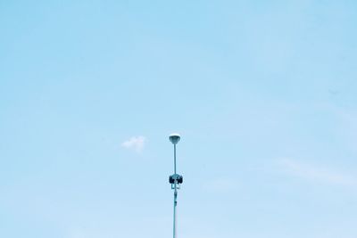 Low angle view of street light against blue sky