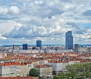 Cityscape against cloudy sky