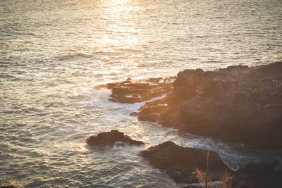 High angle view of rocks next to sea