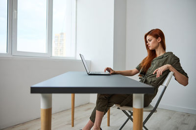 Young woman using laptop at home