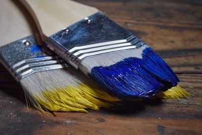 Close-up of paintbrushes on wood