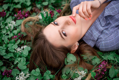 Portrait of woman lying down on plant