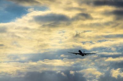 Low angle view of airplane flying in sky