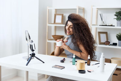 Portrait of young woman working at home