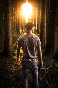 Man standing in forest at night