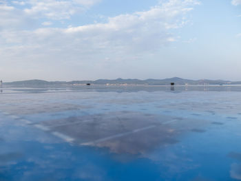 View of calm sea against cloudy sky