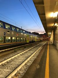 Train at railroad station against sky