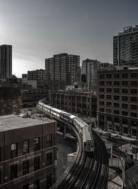 Elevated train along built structures