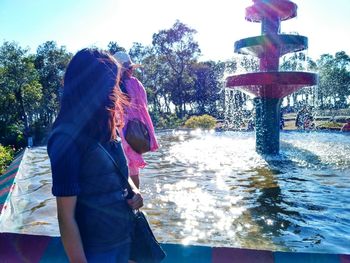 Full length of woman splashing water