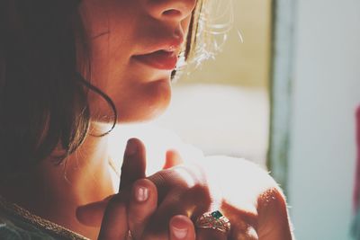 Close-up portrait of young woman at home